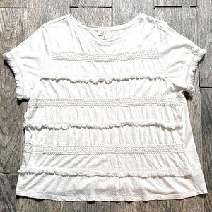 Style & Co white tee with stripes of fringe and crochet